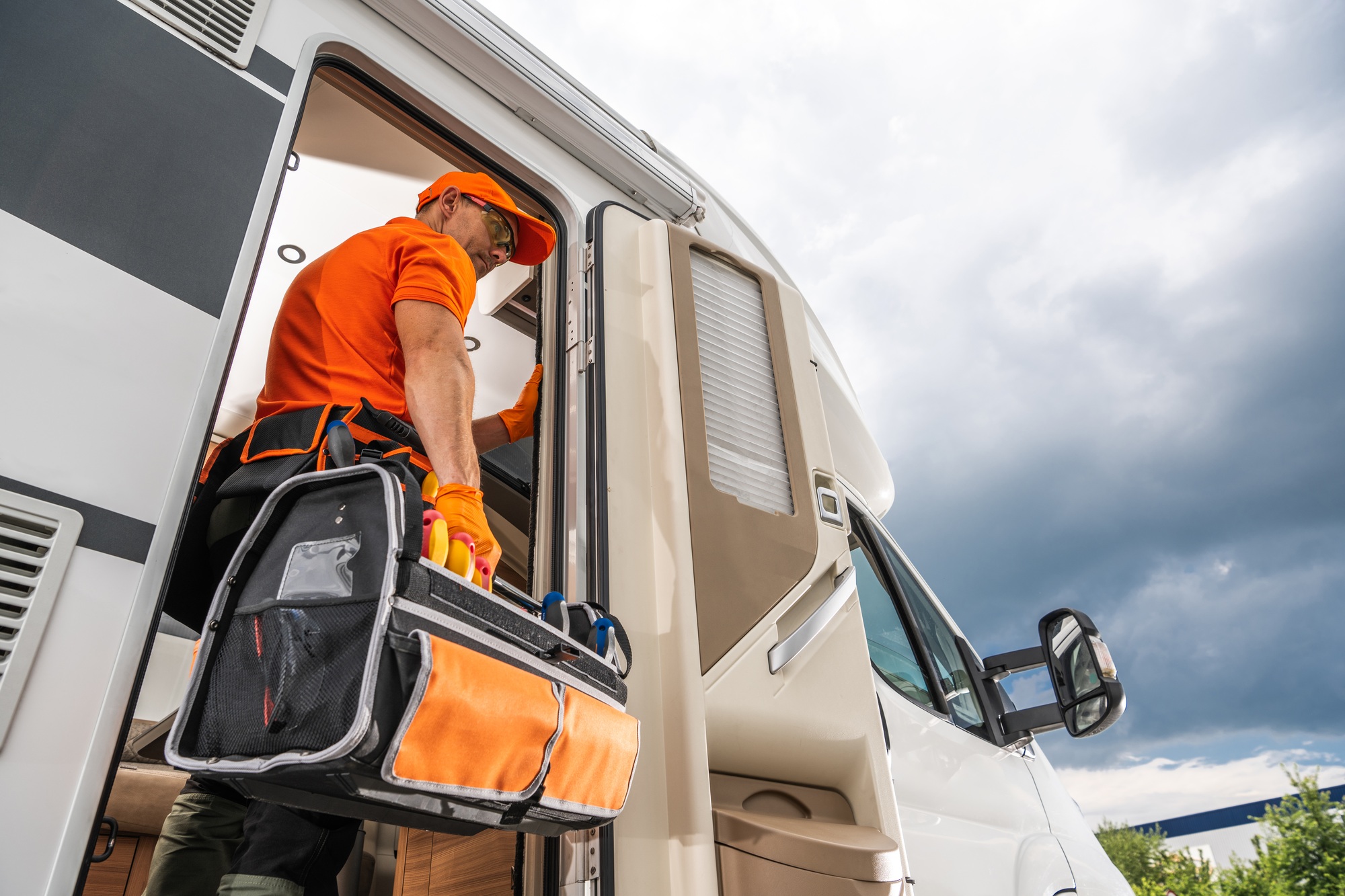 Technician Entering RV With Tool Bag Needed For Repair.